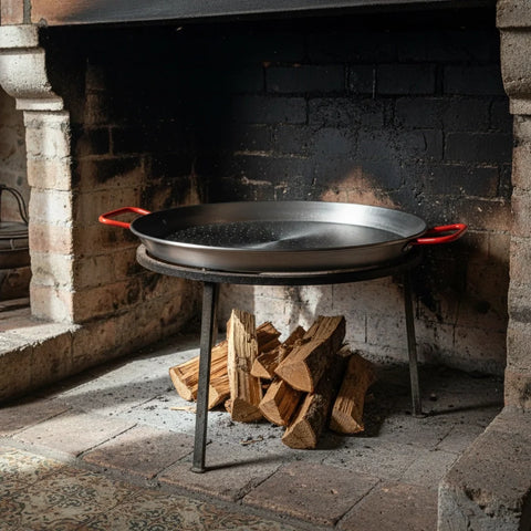 El Paeller Polished Carbon Steel Paella Pan - pan over a wood fire in a fireplace